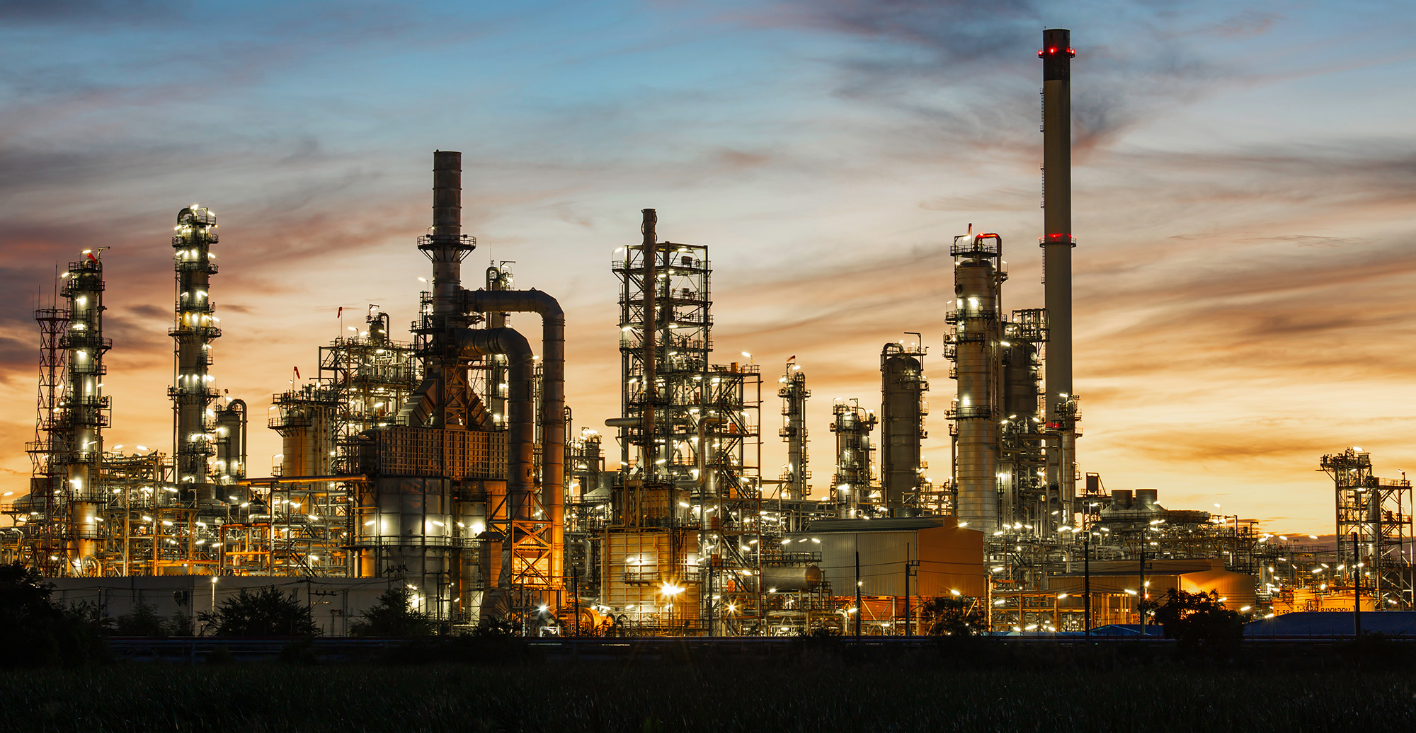 Oil​ refinery​ and​ plant and tower column of Petrochemistry industry in oil​ and​ gas​ ​industrial with​ cloud​ orange​ ​sky the sunrise​ background​